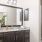 well lit bathroom with walk-in glass enclosed shower