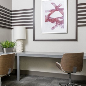 Business Center desktop counters with chairs in bright corner of the business center